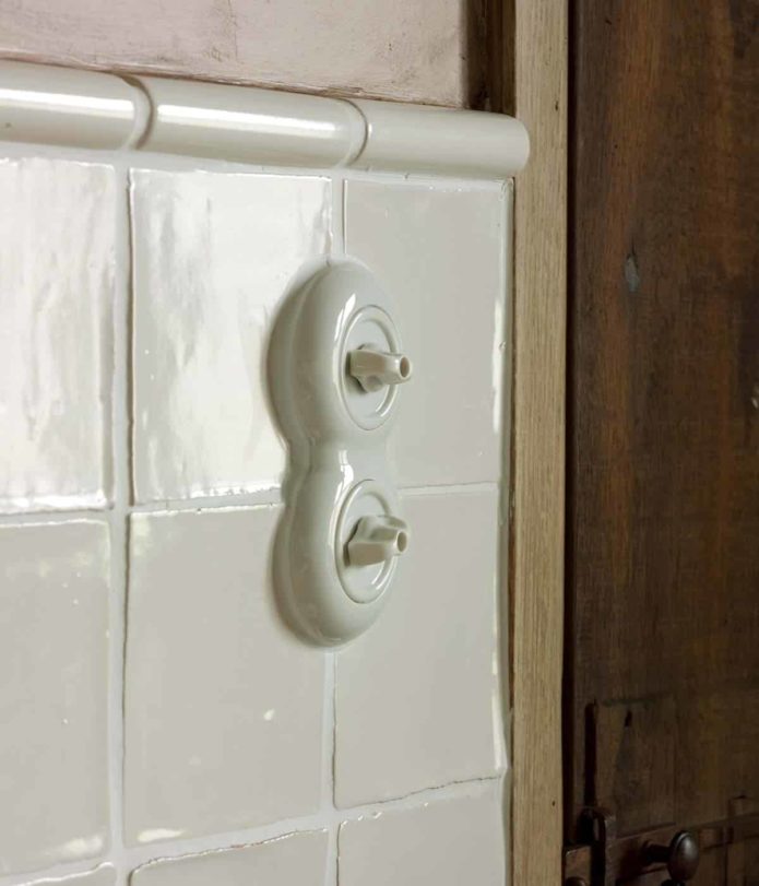 THPG Porcelain Rotary light switch on tiled wall